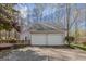 Detached two-car garage with wooden deck and adjacent driveway at 65 Dundee Pl, Sharpsburg, GA 30277