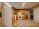 Functional kitchen featuring brick-look tile flooring, wooden cabinets and white appliances at 65 Dundee Pl, Sharpsburg, GA 30277