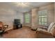 Spacious living room with a television, recliner, and natural light from the windows at 65 Dundee Pl, Sharpsburg, GA 30277