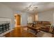 Inviting living room featuring a fireplace, wood floors, and comfortable seating at 65 Dundee Pl, Sharpsburg, GA 30277