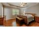 Spacious main bedroom with trey ceiling, wood floors, and a large window at 65 Dundee Pl, Sharpsburg, GA 30277