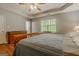 Spacious main bedroom featuring a ceiling fan, trey ceiling, and a large window at 65 Dundee Pl, Sharpsburg, GA 30277