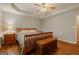 Spacious main bedroom with trey ceiling, wood floors, and warm lighting at 65 Dundee Pl, Sharpsburg, GA 30277