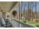 Inviting porch with comfortable seating offers serene views of the surrounding greenery and nature at 65 Dundee Pl, Sharpsburg, GA 30277