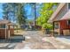 View of a spacious backyard and detached garage with a gravel driveway at 111 Highway 138 E, Stockbridge, GA 30281