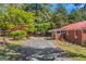 View of home's backyard featuring detached garage, brick walkway and driveway at 111 Highway 138 E, Stockbridge, GA 30281