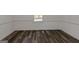 Bright bedroom featuring white walls, wood-look vinyl flooring and one window at 111 Highway 138 E, Stockbridge, GA 30281