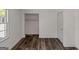 Bedroom featuring white walls, wood-look vinyl flooring, window and closet at 111 Highway 138 E, Stockbridge, GA 30281