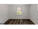 Bright bedroom featuring white walls, wood-look vinyl flooring and two windows at 111 Highway 138 E, Stockbridge, GA 30281