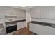 Traditional kitchen featuring gray cabinetry, black countertops, and stainless steel appliances at 111 Highway 138 E, Stockbridge, GA 30281