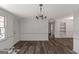 Bright living room with hardwood floors and modern light fixture at 111 Highway 138 E, Stockbridge, GA 30281
