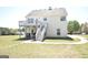 Spacious backyard featuring a two-story home with a deck and well-maintained lawn at 116 Ducati Dr, Mcdonough, GA 30252