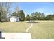Backyard with a shed, fire pit area, and a stone pathway through the lawn at 116 Ducati Dr, Mcdonough, GA 30252