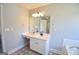 Bathroom featuring white vanity sink, light fixture, wall mirror, and tile flooring at 116 Ducati Dr, Mcdonough, GA 30252