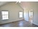 Bedroom featuring hardwood floors, two windows, and ensuite bathroom at 116 Ducati Dr, Mcdonough, GA 30252