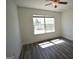 Bright bedroom with modern vinyl flooring, ceiling fan, and large window offering natural light at 116 Ducati Dr, Mcdonough, GA 30252