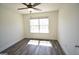 Bedroom featuring ceiling fan, window, hardwood flooring, and white walls at 116 Ducati Dr, Mcdonough, GA 30252