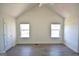 Spacious bedroom with modern flooring, two large windows, and ample natural light at 116 Ducati Dr, Mcdonough, GA 30252