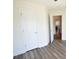 Bedroom featuring neutral walls, new vinyl flooring, and a closet for ample storage at 116 Ducati Dr, Mcdonough, GA 30252