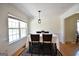 Dining area with a large window, a table set for four, hardwood floors and a view of the backyard at 116 Ducati Dr, Mcdonough, GA 30252