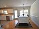 Bright dining area with hardwood floors, a table set for six and access to the kitchen at 116 Ducati Dr, Mcdonough, GA 30252
