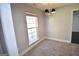 Bright dining room featuring tile flooring, a modern chandelier, and a large window at 116 Ducati Dr, Mcdonough, GA 30252