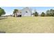 Exterior showcasing a two-story home with a spacious, grassy yard and a long driveway at 116 Ducati Dr, Mcdonough, GA 30252