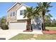 Charming two-story home featuring stone accents, a front-facing garage, and lovely palm trees flanking the entrance at 116 Ducati Dr, Mcdonough, GA 30252