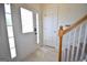 Bright foyer featuring tile flooring, a glass-paneled front door, and a staircase with wood railing at 116 Ducati Dr, Mcdonough, GA 30252