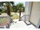 Covered front porch with white railings, palm tree views, and a stepping stone pathway at 116 Ducati Dr, Mcdonough, GA 30252
