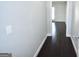 Hallway featuring sleek, dark wood floors and light, neutral walls at 116 Ducati Dr, Mcdonough, GA 30252
