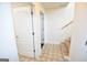 Hallway leading to carpeted stairs, with tile flooring, and white trim at 116 Ducati Dr, Mcdonough, GA 30252