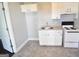 Bright kitchen featuring white cabinets, a stainless steel sink, and new appliances at 116 Ducati Dr, Mcdonough, GA 30252