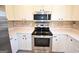 Kitchen showcasing stainless steel appliances, white cabinets, white countertops and tiled backsplash at 116 Ducati Dr, Mcdonough, GA 30252