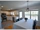 Kitchen next to the dining area, featuring white cabinets, stainless steel appliances and tiled floors at 116 Ducati Dr, Mcdonough, GA 30252