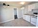Cozy kitchen with white cabinetry, a stove, and access to another room at 116 Ducati Dr, Mcdonough, GA 30252