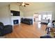 Open-concept living room with hardwood floors, fireplace and a view of the kitchen and dining area at 116 Ducati Dr, Mcdonough, GA 30252