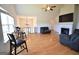 Spacious living room with hardwood floors, fireplace, ceiling fan, and a view of an upper level at 116 Ducati Dr, Mcdonough, GA 30252