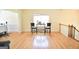 Sitting area with hardwood floors, a bright window and furniture, next to the stairs to the upper level at 116 Ducati Dr, Mcdonough, GA 30252
