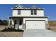 Charming two-story home with a two-car garage, brick accents, and meticulously landscaped front yard at 571 Cantrell Drive, Dallas, GA 30157