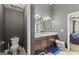 This bathroom offers a double sink vanity, dark cabinetry, and an enclosed toilet area at 6870 Diamond Dr, Rex, GA 30273