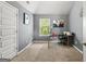 Cozy bedroom featuring neutral carpet, gray walls, and natural light from the window at 6870 Diamond Dr, Rex, GA 30273