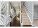 Inviting entryway with hardwood floors, staircase, and view into the dining area at 6870 Diamond Dr, Rex, GA 30273