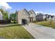 Two-story home with a well-manicured front lawn and a paved driveway with a trailer at 6870 Diamond Dr, Rex, GA 30273