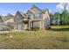 Well-maintained two-story home with a manicured lawn and a two-car garage on a sunny day at 6870 Diamond Dr, Rex, GA 30273