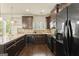Modern kitchen with stainless steel appliances, dark wood cabinets, and beautiful granite countertops at 6870 Diamond Dr, Rex, GA 30273