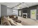 This inviting living room features a fireplace, large sectional sofa, ceiling fan, and neutral tones at 6870 Diamond Dr, Rex, GA 30273