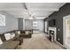 Cozy living room boasts a large sectional sofa, fireplace, ceiling fan, and neutral color scheme at 6870 Diamond Dr, Rex, GA 30273