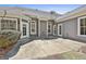 View of the back patio with gray siding, white trim, and door and window access to the home at 410 Denton Cir, Fayetteville, GA 30215