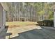 Backyard featuring a concrete patio and a wooded area with mature trees at 410 Denton Cir, Fayetteville, GA 30215